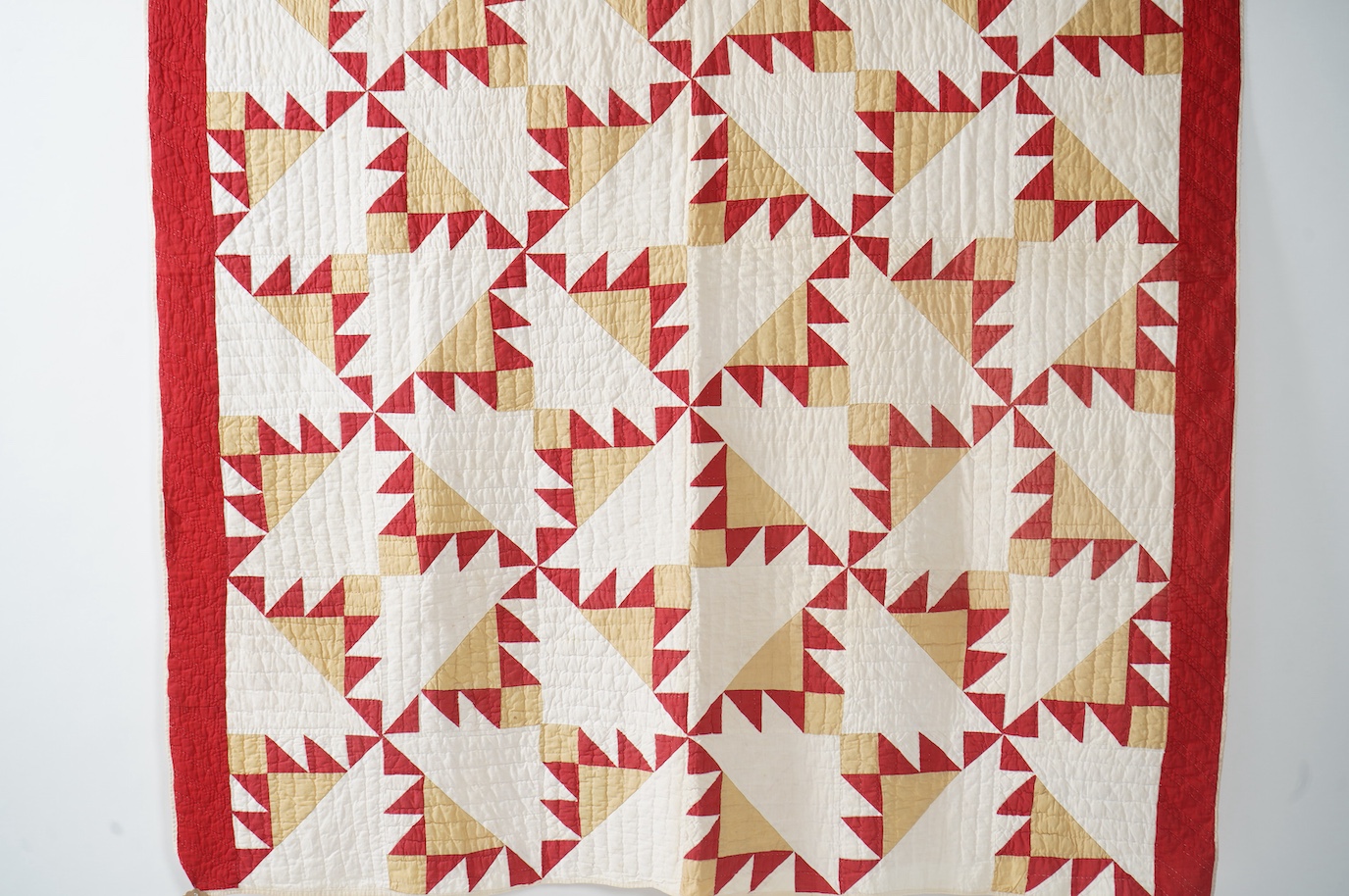 An early 1920’s-30’s American Virginian hand patch work, hand quilted bed cover. Called ‘Delectable Mountain Block’, worked in plain cottons of red, white and ochre, with a plain white backing and simple wadding. 182cm x